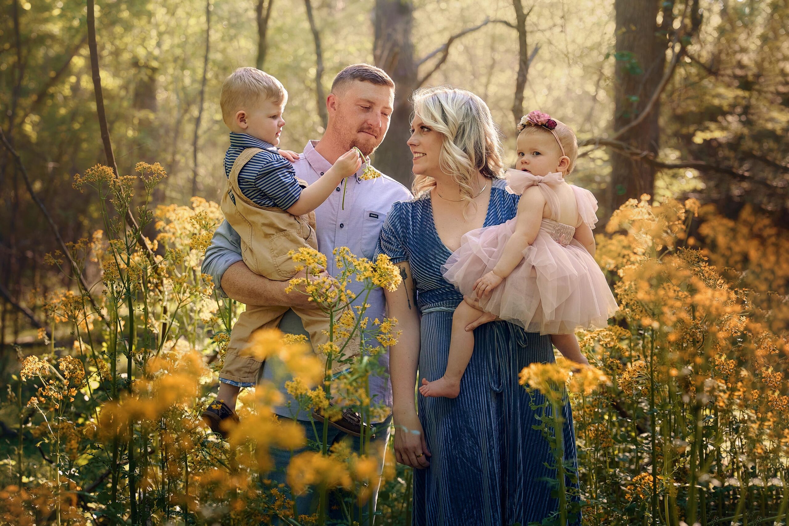 Natural Scenic Family Photography with a mom, dad, and two children in a wild flower field